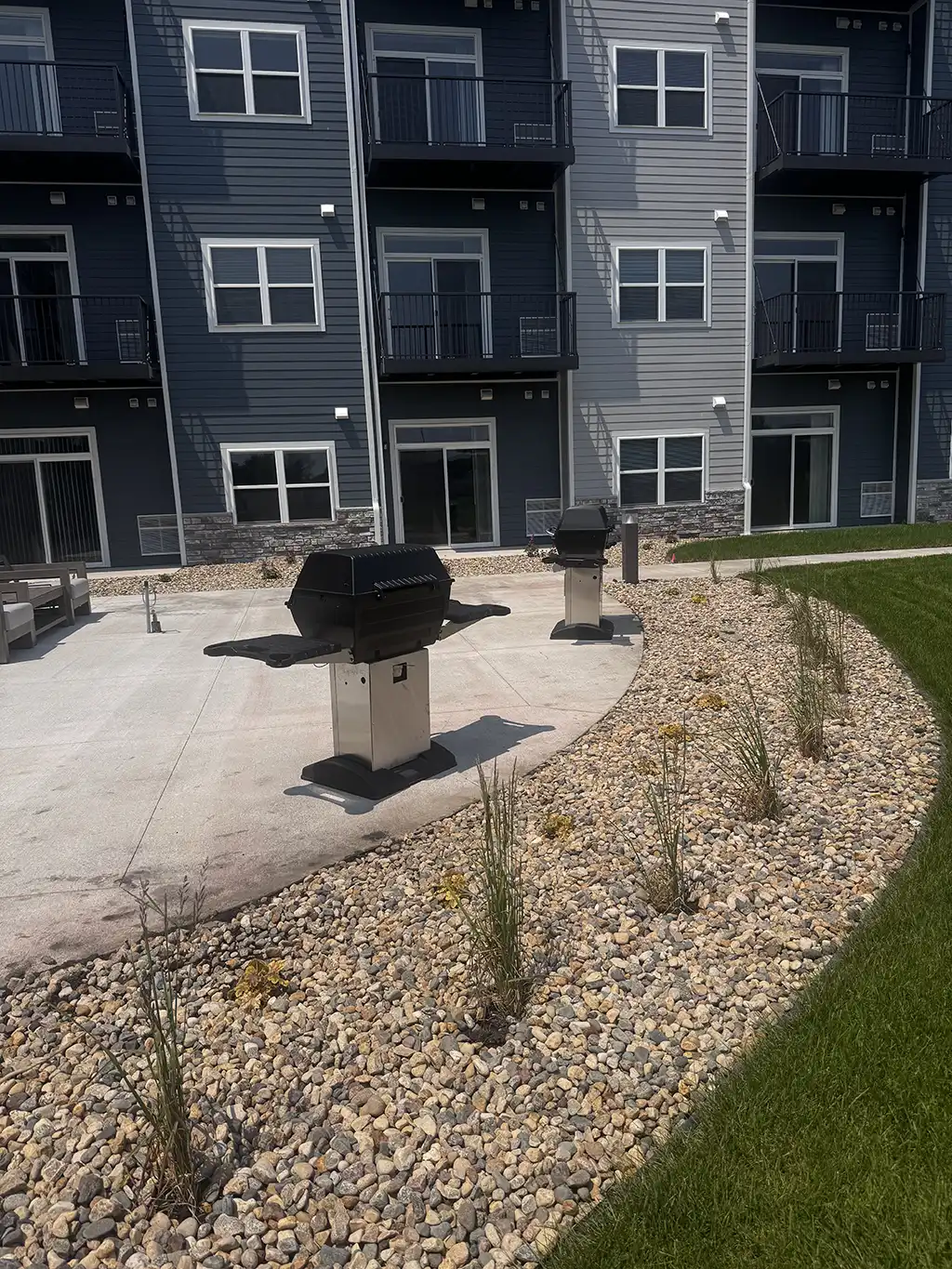 exterior of condos with grills on patio