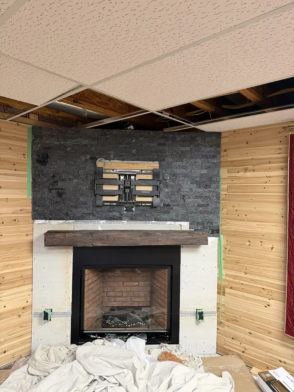 Custom corner fireplace with tv by River City Fireplaces